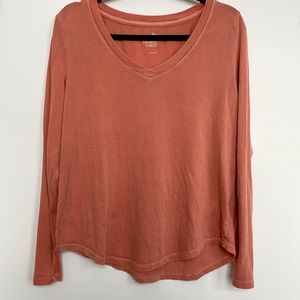 Light orange long sleeve shirt. Fits loosely. Perfect for Fall layering.